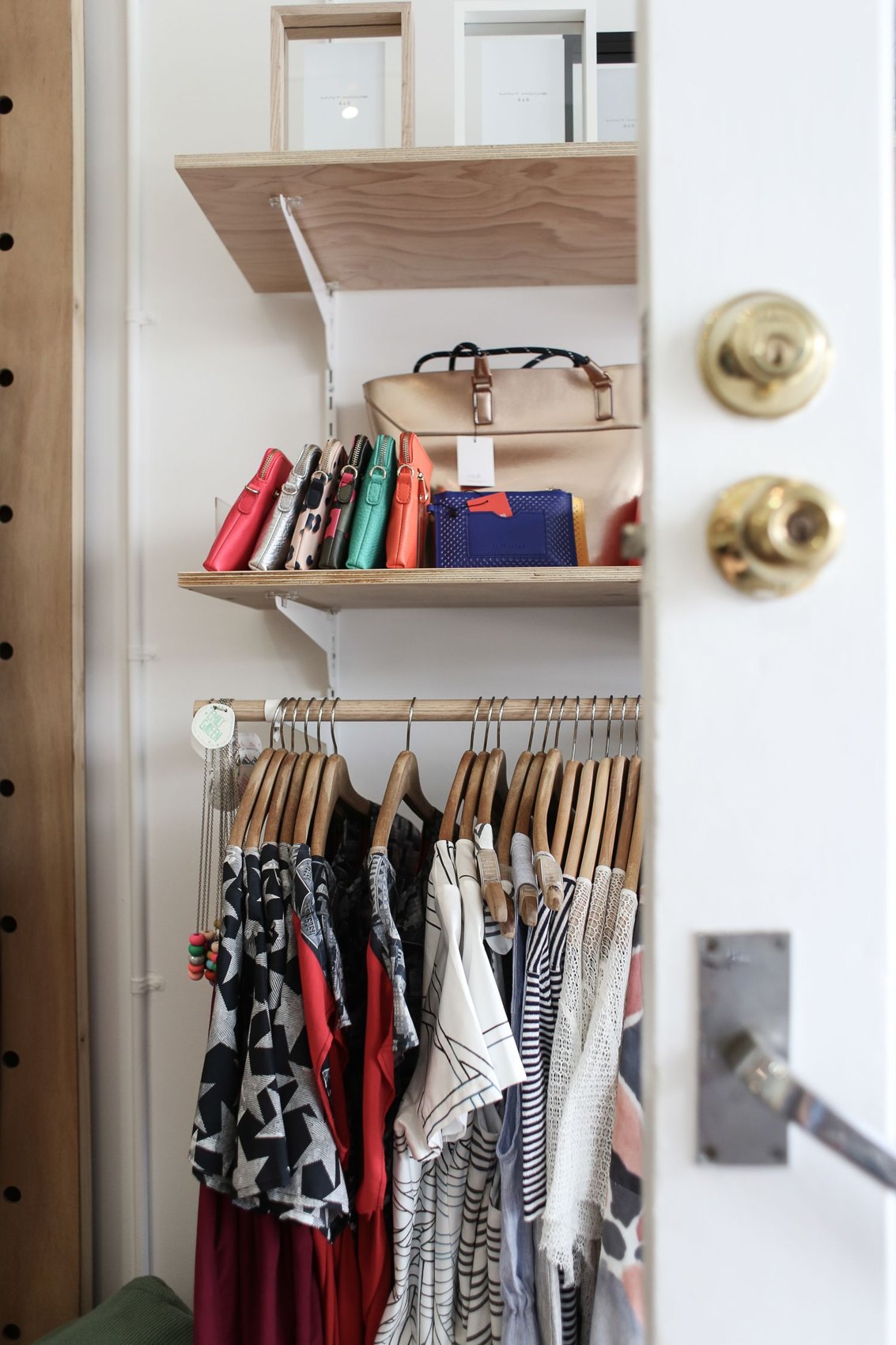 Clothes and bags in an organised wardrobe