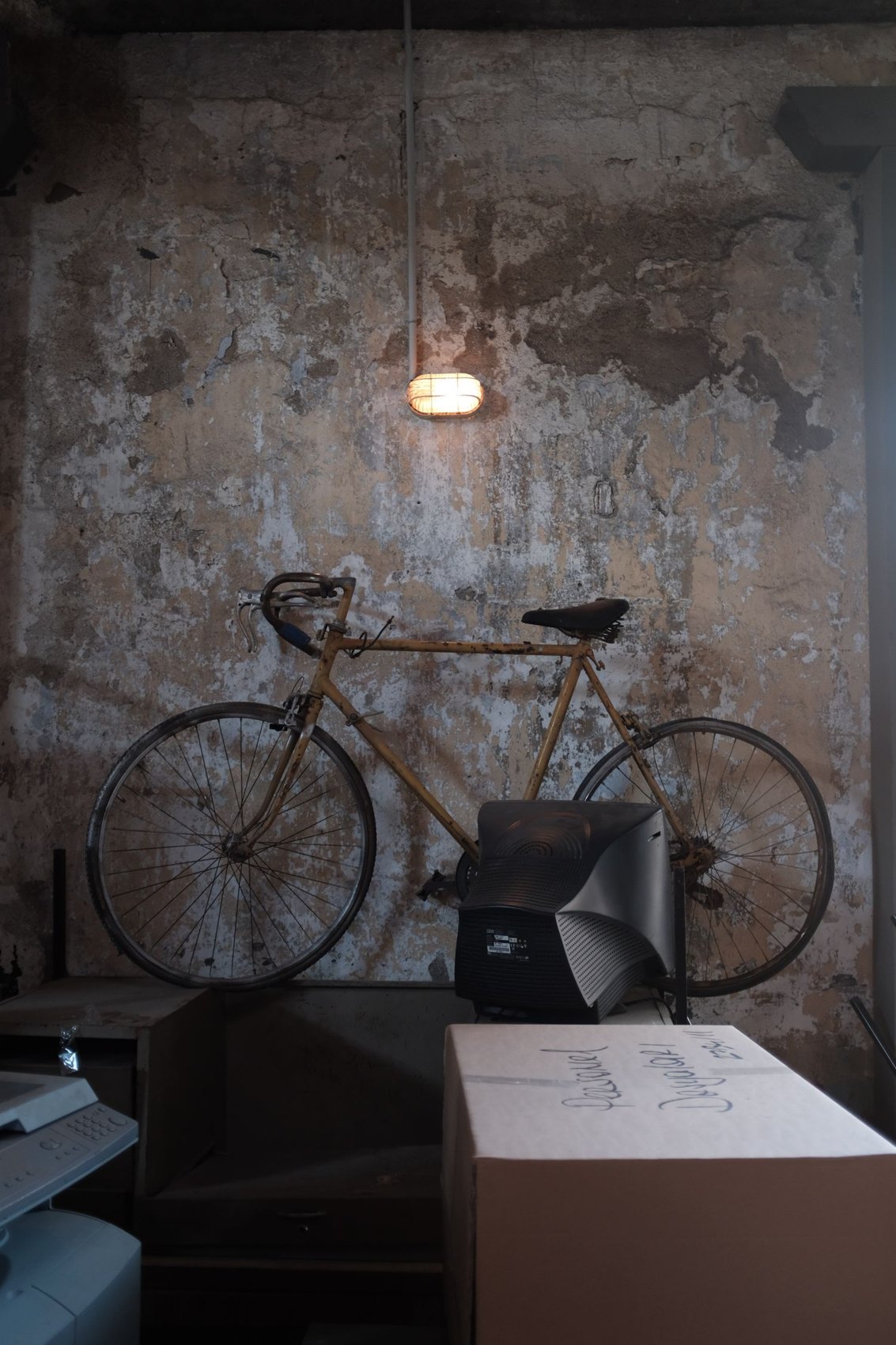 Boxes and a bicycle in a cellar room