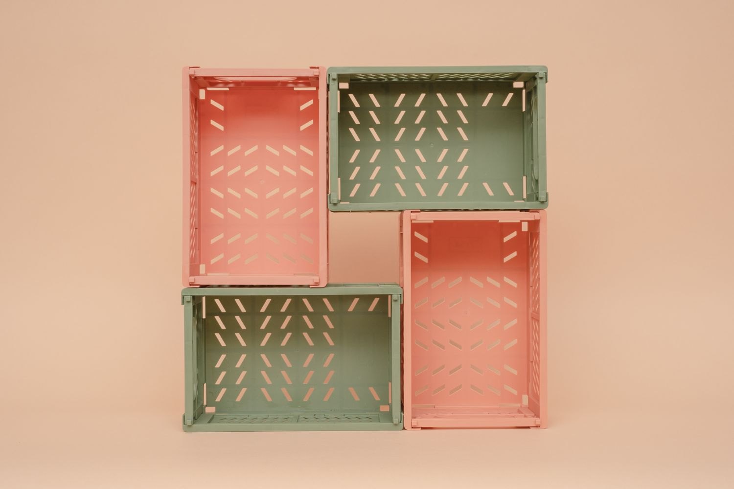 Four small folding plastic crates