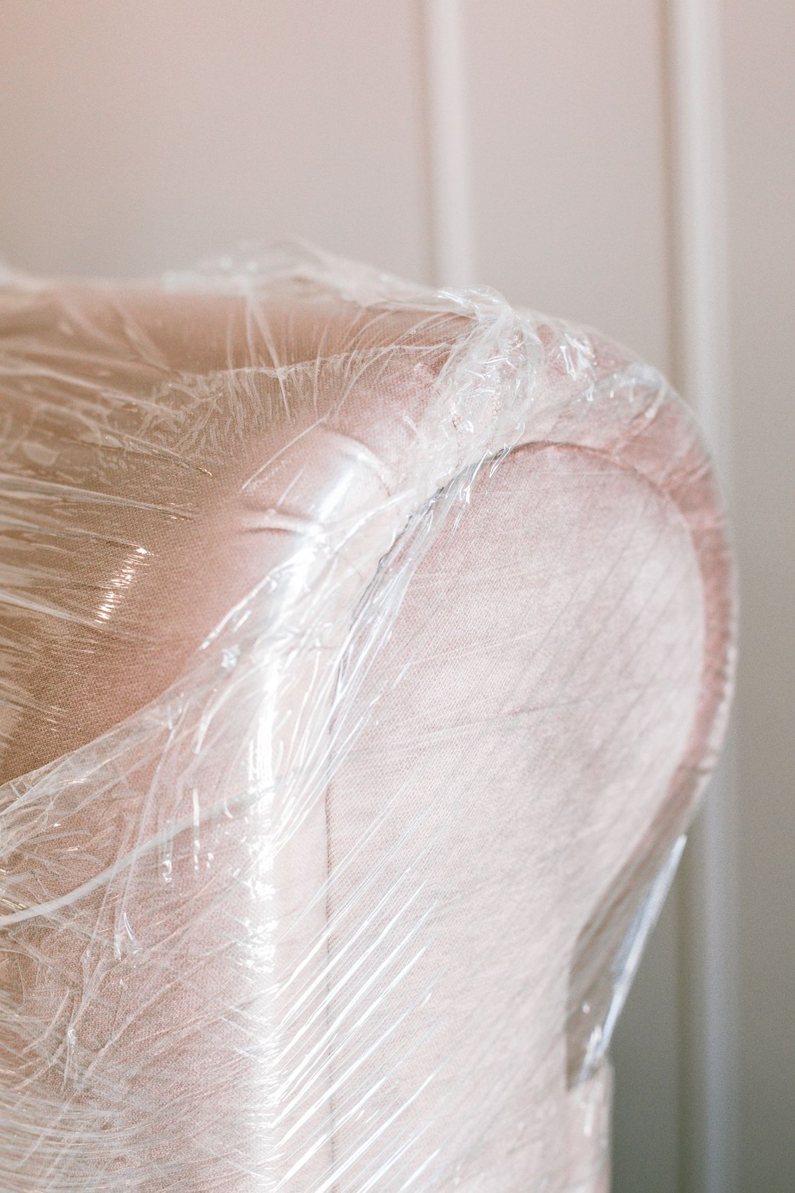 An armchair wrapped in clear protective film